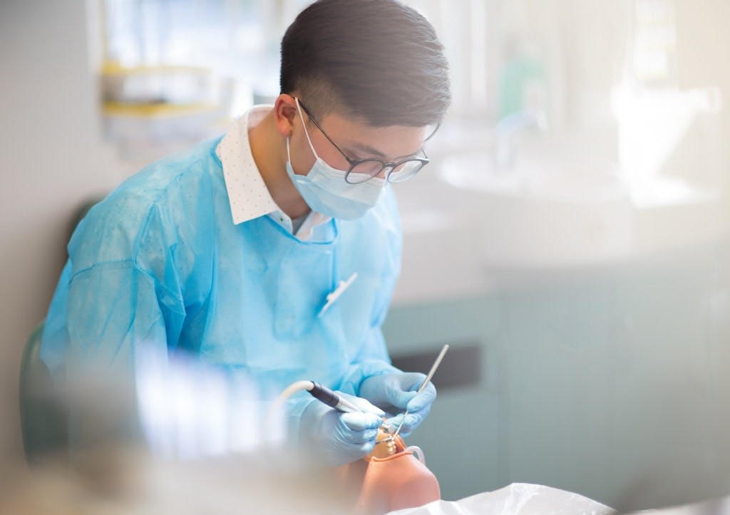  A male dentist working with a patient