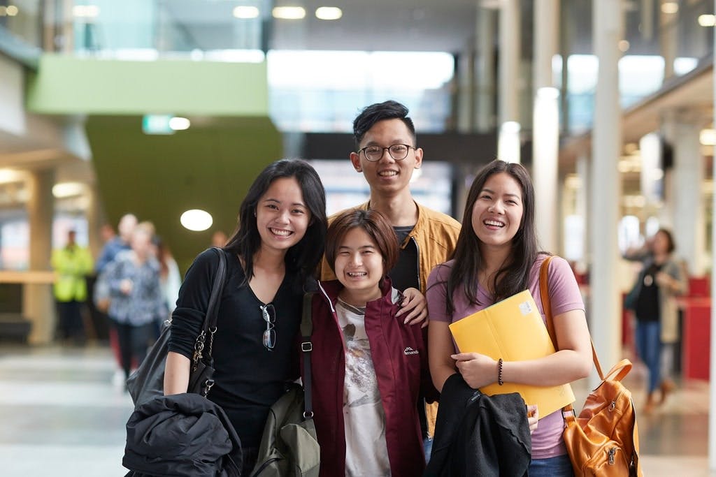 International students smiling at a camera