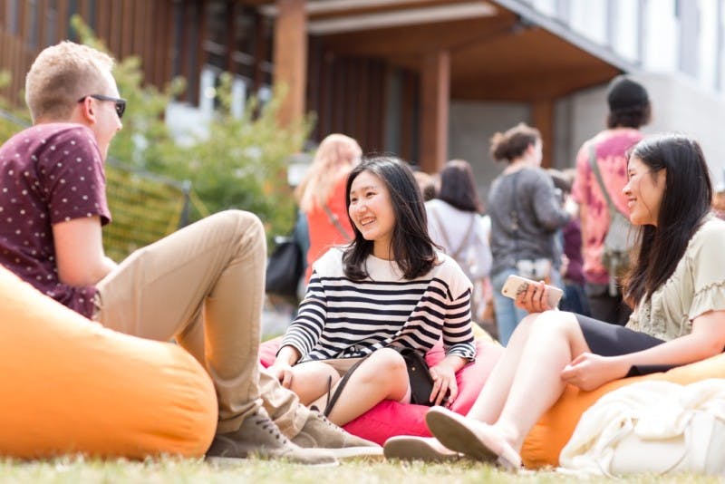 A few students chatting happily on the lawn