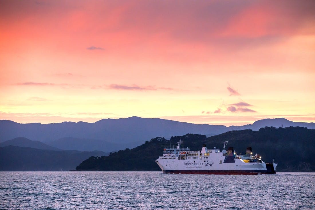 The Interislander ferry crossing during sunset between the North Island and the South Island in New Zealand. 