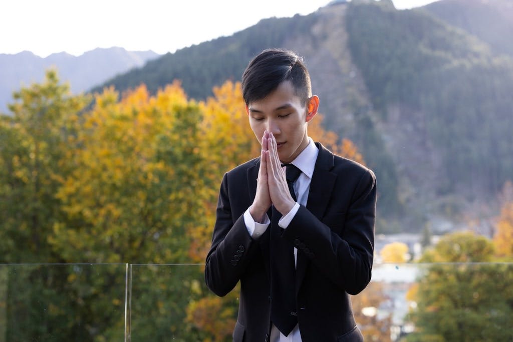 a person praying in a natural environment