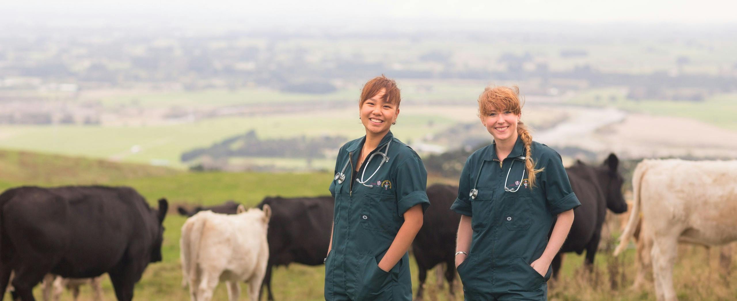Two female veterinary student on a dairy farm.