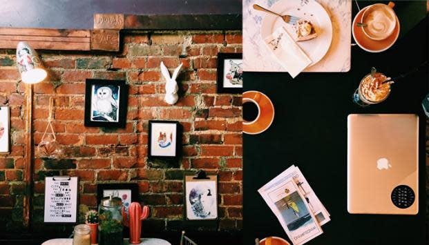 A collage of two images shows funky cafe decor with many framed pictures hanging on a brick wall. The second image shows a birds' eye view of a cafe table with coffees and a laptop. 